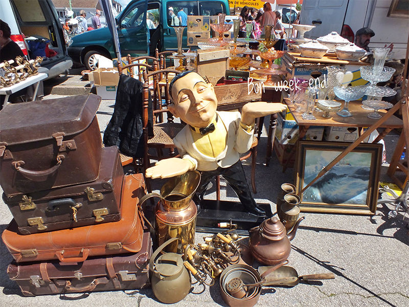 Array of copper pots, leather cases and ornaments at a flea market